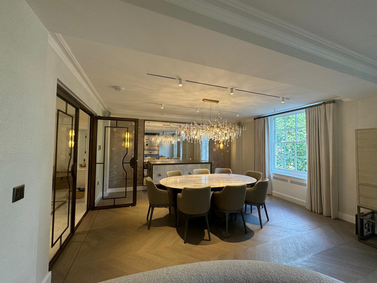 Completed New Level dining room with steel-framed doors and parquet floor