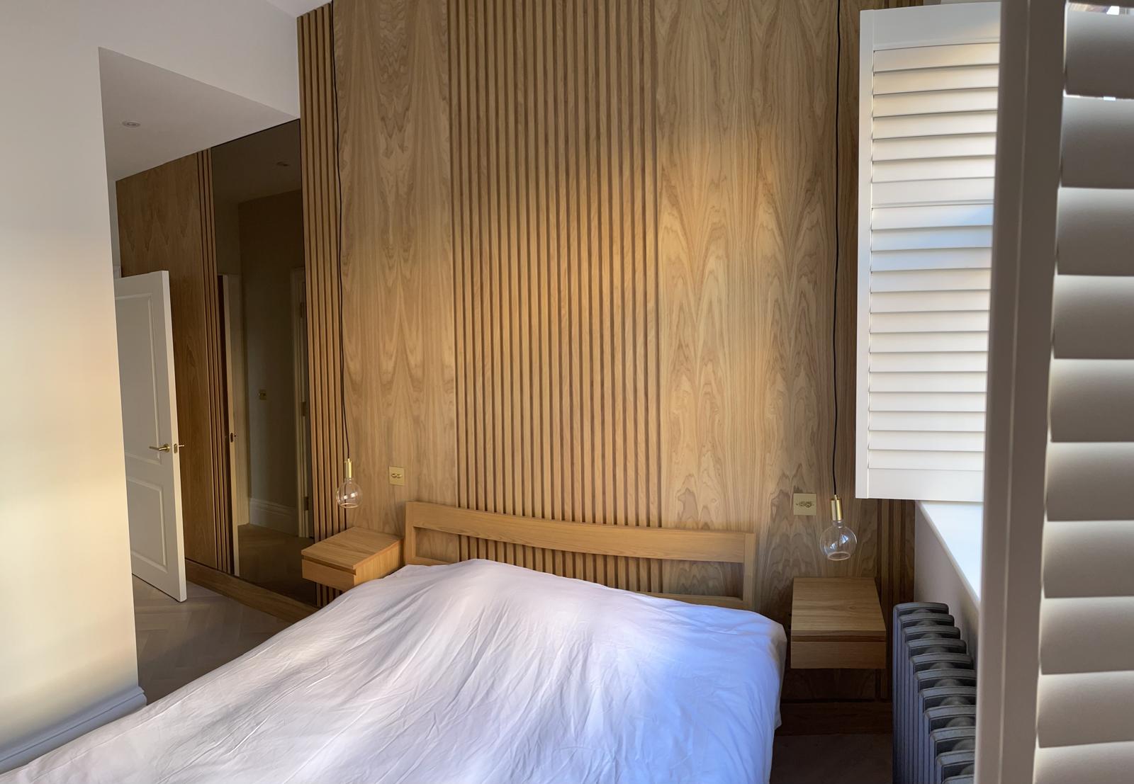 New Level fluted oak bedroom feature wall and bespoke joinery